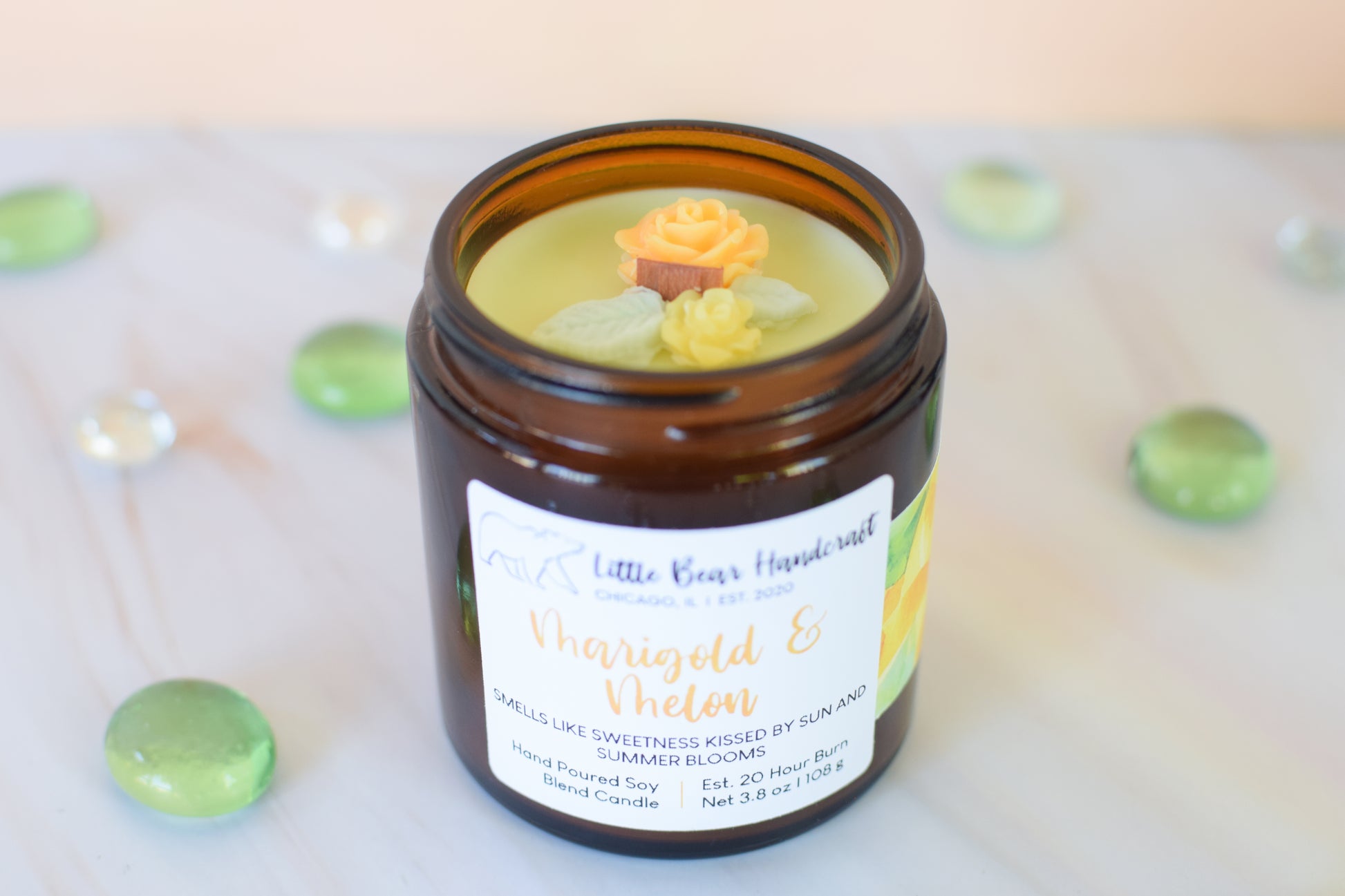 Jar of candle with decorative rose on top and 'Little Bear Handmade' label.